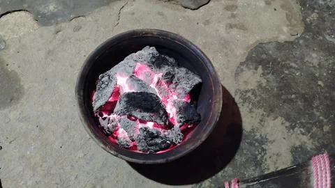 There is fire of cow dung in the earthen pot Stock Photos