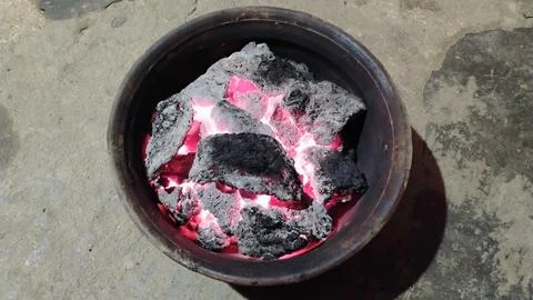 There is fire in an earthen pot and it is very good Stock Photos