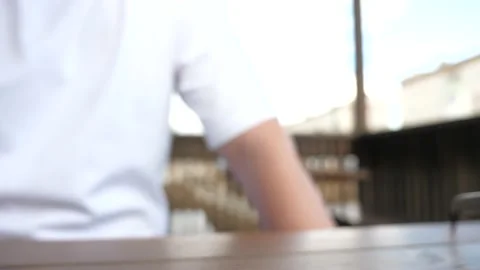 There is a glass of coffee on table, man is drinking aromatic delicious coffee Stock Footage 148143840