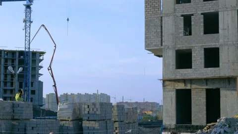 There is a gray unfinished building without windows, next to it on gray blocks Stock Footage 148706060