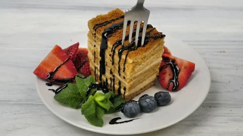 There is a honey layer cake. Biting a cake with a fork.Sweet breakfast. Stock Footage 235746970