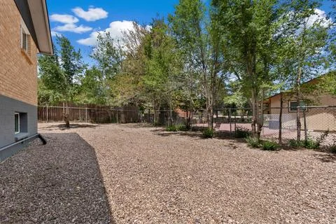 There is a house that features a large amount of gravel in front of it Stock Photos