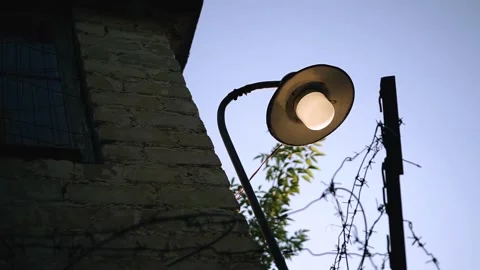 There is a lantern on the corner of the old house against the sunset background Stock Footage 337847551
