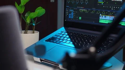 There is a laptop on the table next to a flower. Video editor open on laptop scr Stock Footage 267100973