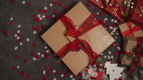 There is a large box with a Christmas present spinning on the table. Видео 165119206