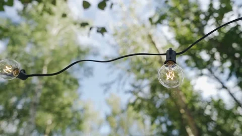 There is a light bulb hanging on a black wire Stock Footage 166519991