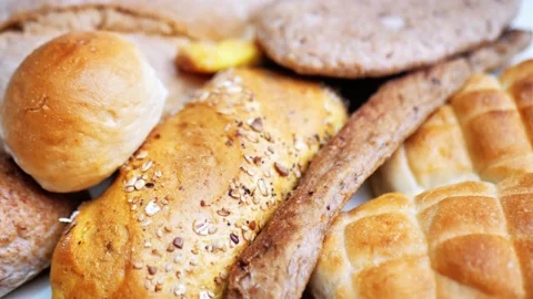 There is a lot of different bread on the table. Close-up, top view. Food concept Stock Footage 227594023