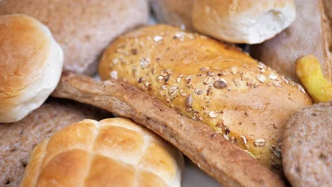 There is a lot of different bread on the table. Close-up, top view. Food concept Stock Footage 230079682