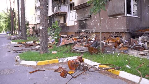 There is a lot of trash on the side of the road in front of a building Stock Footage 264323792