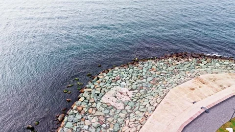 There is a man that is standing on a rock ledge Video stock 268942006