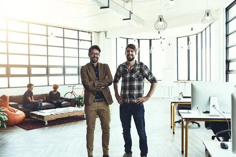 There is no singular rule for success. two designers standing in a modern office Stock Photos
