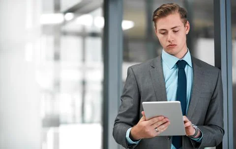There is not task too big for me. a handsome young businessman standing alone in Stock Photos