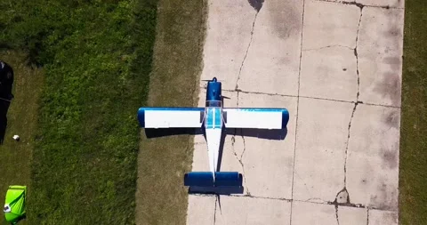 There is an old corn plane in the field, the camera slowly approaches, cars and Video stock 138035115