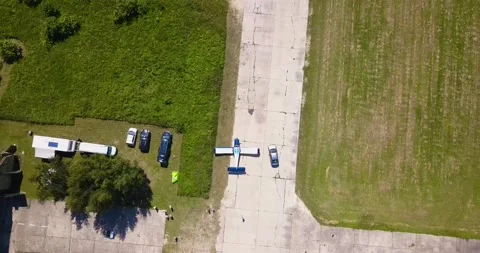 There is an old corn plane in the field, the camera slowly approaches, cars and Video stock 138035142