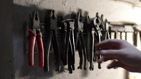 There is an old tool in the garage, the man gets to work Stock Footage 214085844