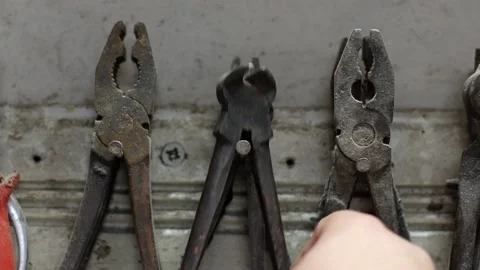 There is an old tool in the garage, the man gets to work Stock Footage 214086016