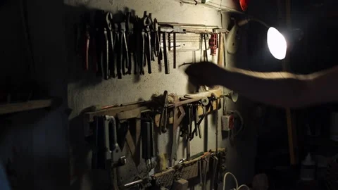 There is an old tool in the garage, the man gets to work Stock Footage 214086561