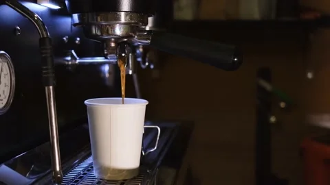 There is a paper coffee cup by the coffee machine Stock Footage 150699883