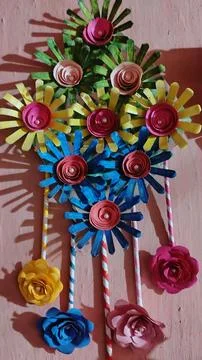 There is a paper wall hanging artwork, possibly made of paper flowers. Stock Photos