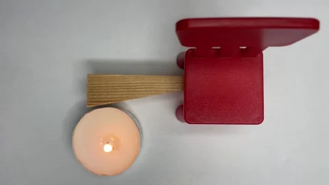 There is a piece of wood lying next to it, there is a red chair and a candle is Stock Footage 252188734