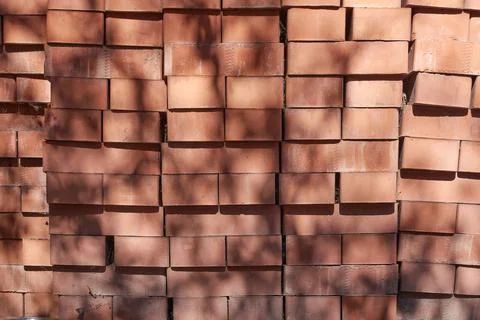 There is a pile of red bricks in the yard. Stock Photos