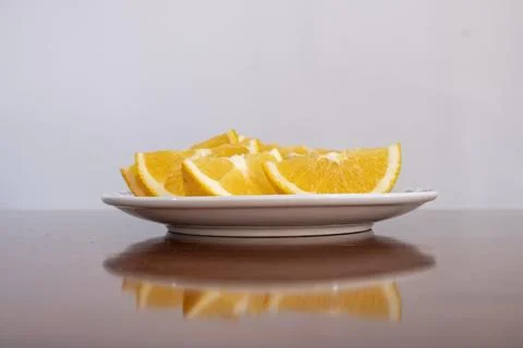 There is a plate of cut oranges on the table Stock Photos