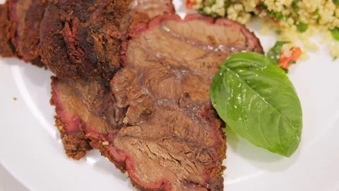 There is a plate of grilled meat on the table. Enjoy the aroma and taste of Stock-Footage 273322725