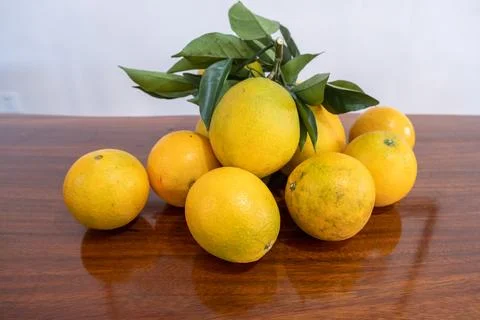 There is a plate of oranges on the table, and there is also a reflection Stock Photos