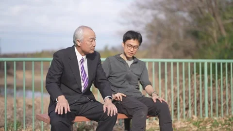 There is plenty of greenery in the spring noon park in Japan. A Japanese man Stock Footage 307378798