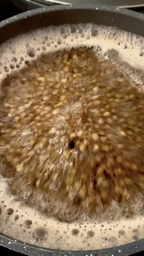There is a pot of boiling soup on the stove. Stock Footage 319953054