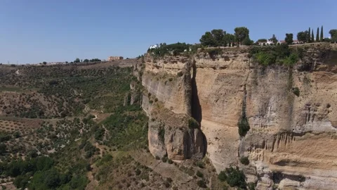 There is a rock tower with a hole on the steep cliffs of Ronda. Stock Footage 152671973