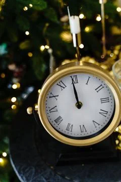 There is a round clock on the black coffee table. New Year, chimes Stock Photos