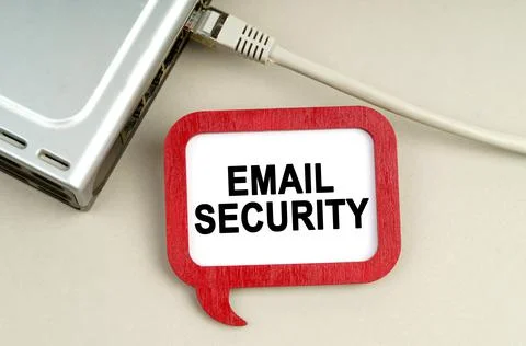 There is a router connected to the network on the table, next to a sign that  Stock Photos