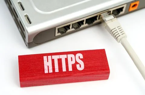 There is a router connected to the network on the table, next to a plaque wit Stock Photos