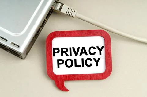 There is a router connected to the network on the table, next to a sign that  Stock Photos