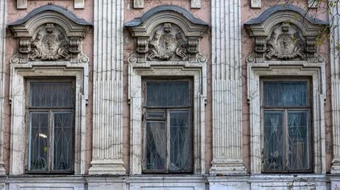 There is a row of windows located on the side of an old building Stock Photos