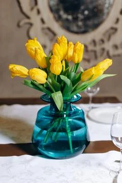 There is a small blue vase on the table. Stock Photos