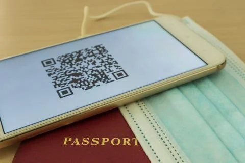There is a smartphone on the table with a QR code of the digital vaccination  Foto stock