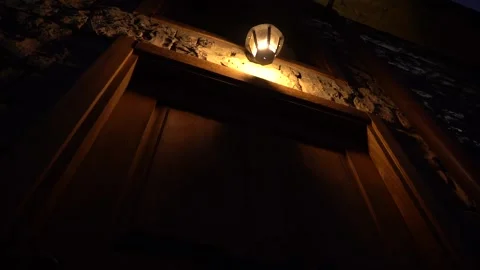 There is a spot light falling on the stair in the dark night on door and window Stock Footage 248831281