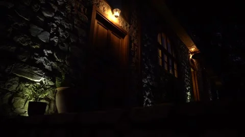There is a spot light falling on the stair in the dark night on door and window Stock Footage 248831283