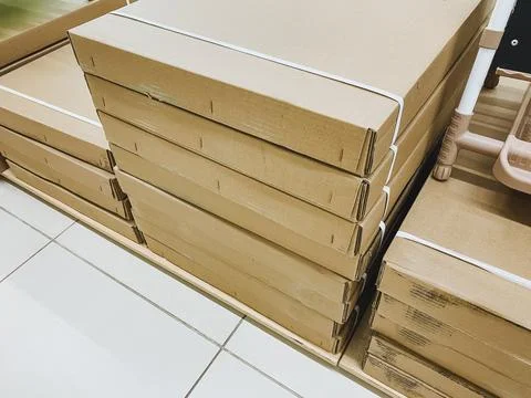 There is a stack of cardboard boxes that are positioned neatly on top of on.. Foto stock