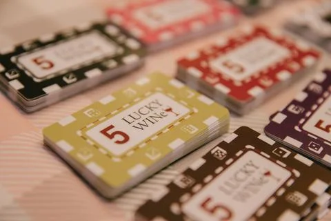 There is a stack of chips and cards on the table for playing at the wine casino Stock Photos