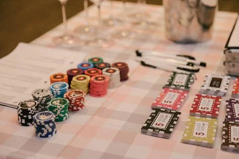 There is a stack of chips and cards on the table for playing at the wine casino Stock Photos