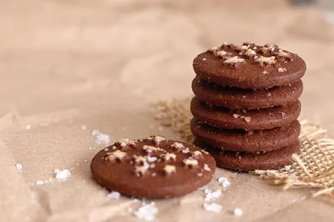 There is a stack of round chocolate christmas cookies with sugar stars and salt Stock-Fotos