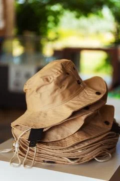 There is a stack of various hats nicely sitting on top of each other on a tab Stock Photos