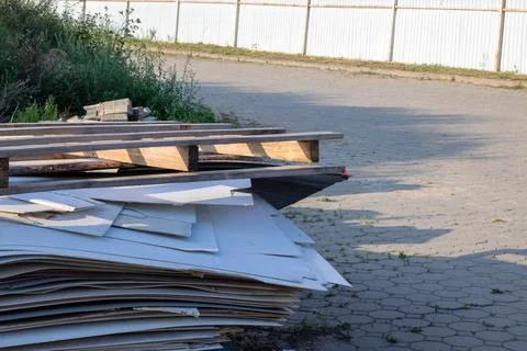 There is a stack of wooden pallets resting on the side of a road Stock Photos