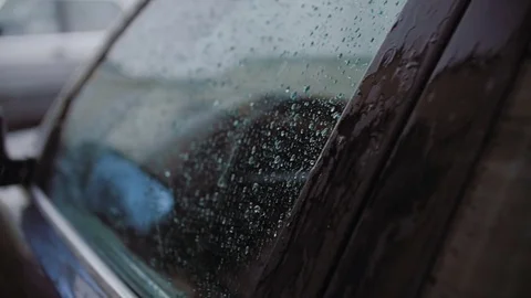 There is a strong summer rain. Drops fall on the car and fight against the glass Stock Footage 78846870