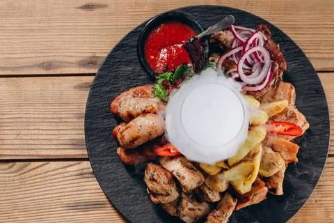 There is a tasty dish in front of the client in the restaurant. Stock Photos