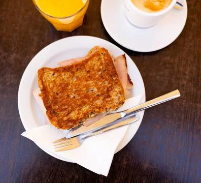 There is thin slice of soft and juicy ham between two slices of bread. Stock Photos