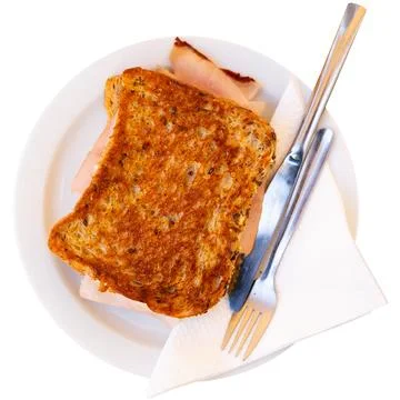 There is thin slice of soft and juicy ham between two slices of bread. 스톡 사진